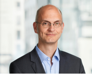 Man with glasses smiling